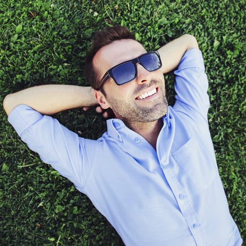 A man lying down on a grassland